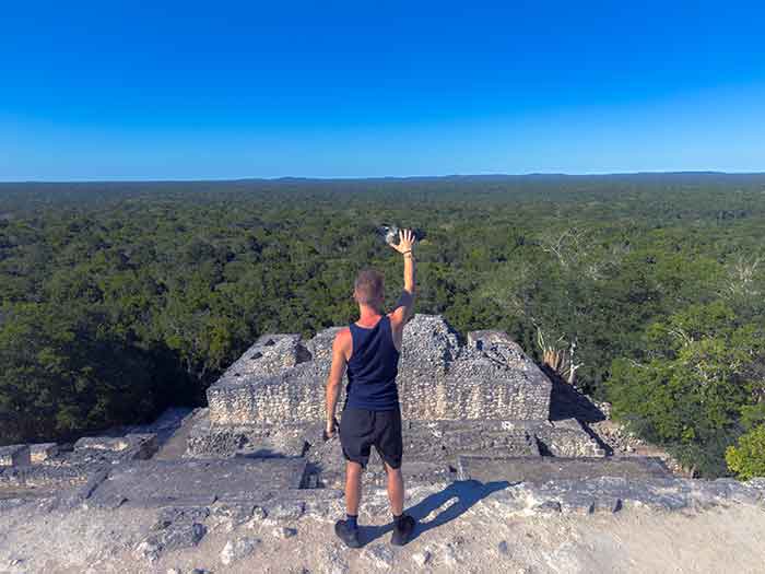 Person overlooking forest from Mayan pyramid